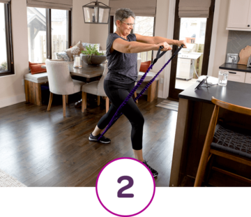 Woman in Living Room Using Resistance Band and #2 in Circle